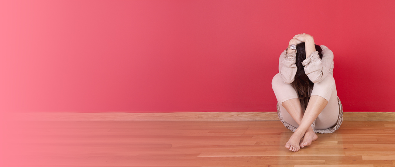 Woman on the floor covering her head